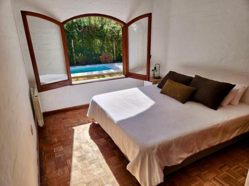 a bedroom with a large bed and a window at Estancia Bogotá in Ciudad Lujan de Cuyo