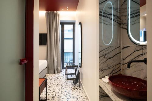 a bathroom with a red sink and a tub at Athens Retro in Athens