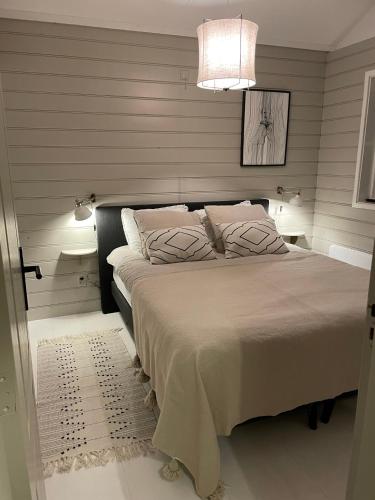 a bedroom with a large bed with a light at Casa Pueblo Viejo in Ouddorp