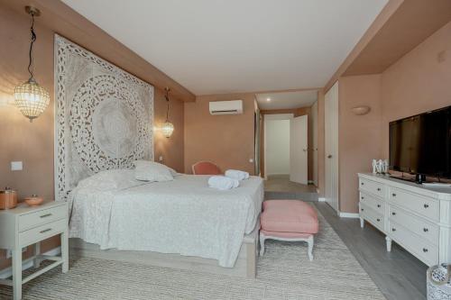 a bedroom with a bed and a flat screen tv at Quinta do Lago Duplex - Beach & Golf Algarve in Loulé