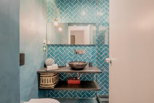 a bathroom with a sink and a mirror at Quinta do Lago Duplex - Beach & Golf Algarve in Loulé