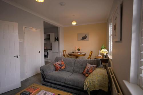 a living room with a couch and a table at Ground floor well appointed cosy flat in Ludlow in Ludlow