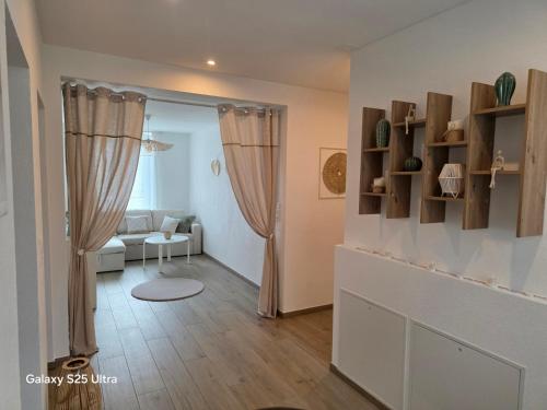 a living room with a couch and a table at Appartement de Charme in Bévilard