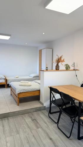 a bedroom with a bed and a table and chairs at u Skiby in Krajno Pierwsze