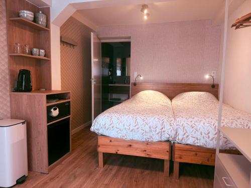 a bedroom with a bed with a wooden bed frame at Garden Room or Economy Room in Amsterdam