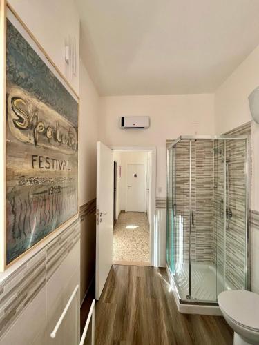 a bathroom with a walk in shower and a toilet at Alloggio Primavera Matilde in Terni