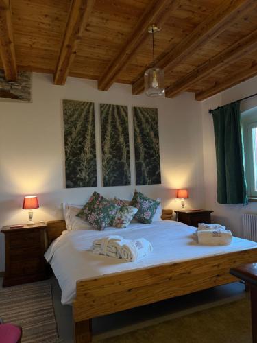 a bedroom with a bed with two towels on it at AGRITURISMO MODOLO Belluno Dolomiti in Belluno
