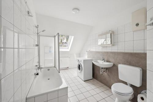 a white bathroom with a toilet and a sink at Worker Place Lennestadt in Lennestadt