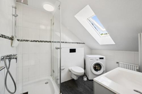 a bathroom with a shower toilet and a sink at Cosy Worker Apartment Olpe in Olpe
