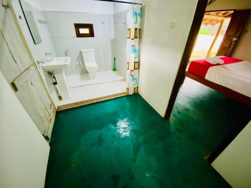 a bathroom with a floor that looks like water at Sunrich Beach Resort in Ilandaiyadi