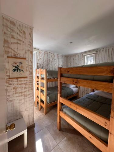 a room with three bunk beds in it at De Peppino Cabañas in Papudo