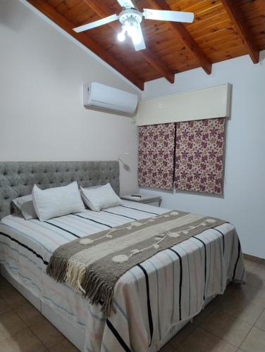a bedroom with a large bed with a ceiling at Miranda House in Estancia San Ramon