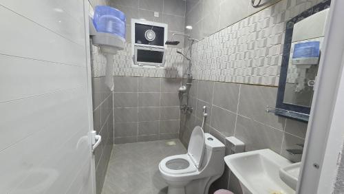 a small bathroom with a toilet and a sink at Suhail Star Guest House in Misfāh