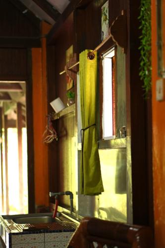 a kitchen with a sink and a window in a room at Swindo Homestay 77, Small House in Berastagi