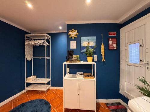 a room with blue walls and a white cabinet at Studio Sto Antonio Alfama in Lisbon