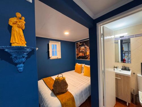 a blue room with a bed and a bathroom at Studio Sto Antonio Alfama in Lisbon