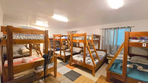a room with four bunk beds in a room at YOLINDA's TOURIST INN in El Nido