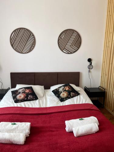 a bedroom with a bed with two towels on it at Wolność in Elblag
