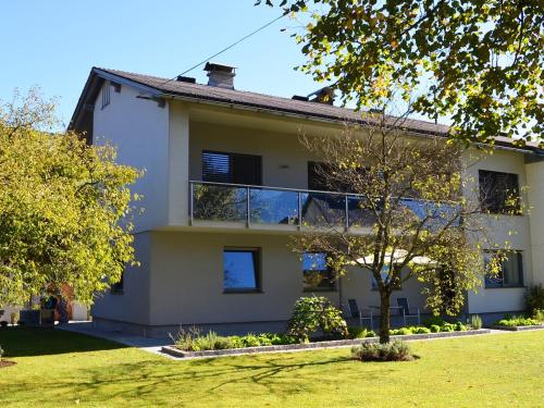 a large white house with a tree in front of it at FEWO Weber in Lukowitz