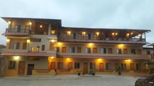 a large building with a balcony on top of it at Hotel Mediterraneo in Canoa