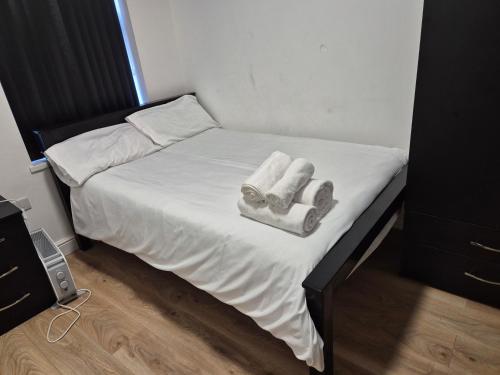 a small bed with two towels on top of it at Comfort Lodge in Nottingham