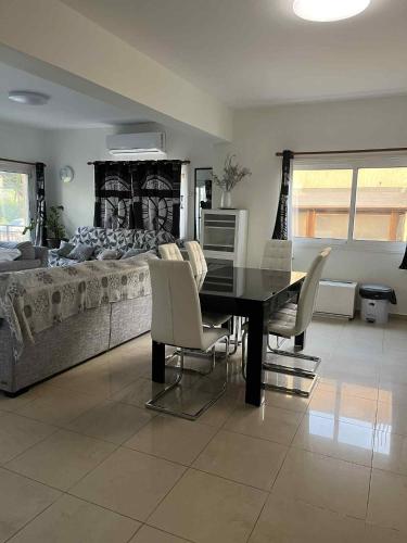 a dining room with a table and chairs and a bed at ANDRIA'S luxury family studio near Casino limassol in Limassol