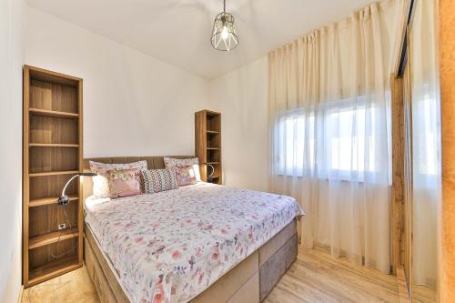 a bedroom with a bed and a window at IPM Apartments Kaštela, parking, pool, 10 minutes from Split airport in Kaštela