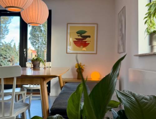 a living room with a dining room table and a table and chairs at Cheerful house, close to lakes in Farum