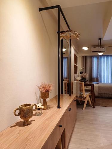 a living room with a wooden counter with a mirror at The Florentine Suite in Manila