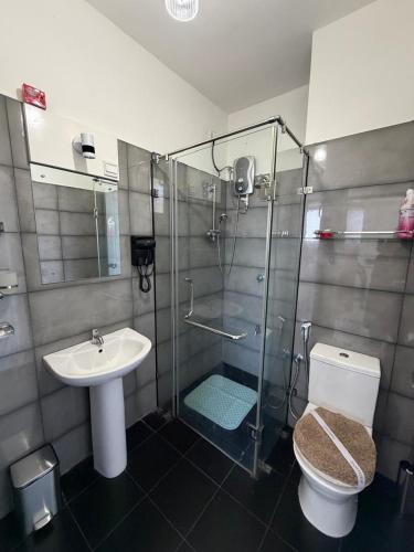 a bathroom with a shower and a toilet and a sink at Oval View Residence by C in Colombo