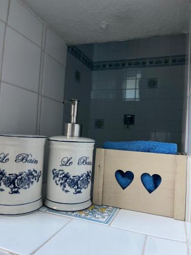 a counter with three cups and a box on it at Relax Luino vista lago Casa LEA in Luino