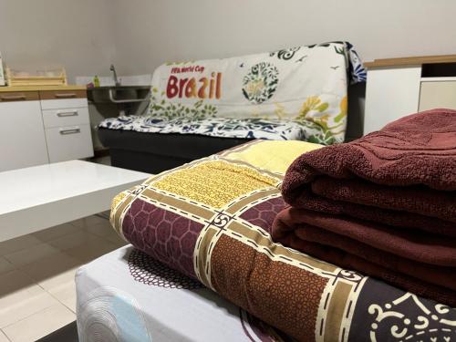 a pile of towels sitting on a bed in a kitchen at Impact Arena C5 by Jintana in Thung Si Kan