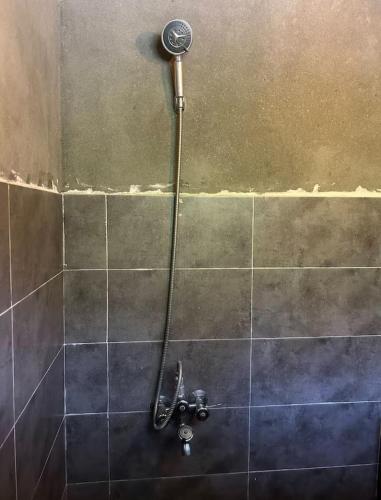 a shower with a shower head in a bathroom at verse hunza in Karimabad Hunza