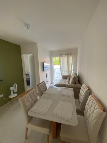 a living room with a table and a couch at Lar caminho da Ilha in Igarassu
