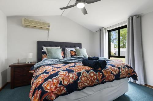 a bedroom with a large bed and a window at Air on Aldersey in McLaren Vale