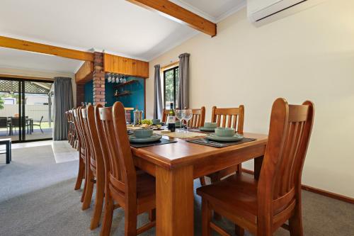 a dining room with a wooden table and chairs at Air on Aldersey in McLaren Vale