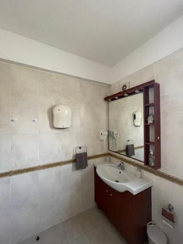 a bathroom with a sink and a mirror and a toilet at Seascape apartment in Larnaca