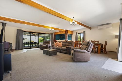 a living room with a couch and chairs and a table at Air on Aldersey in McLaren Vale