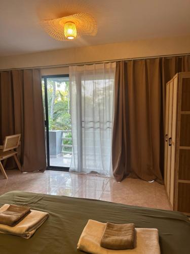 a bedroom with a bed with two towels on it at Nest by Aerial Lanta in Ko Lanta