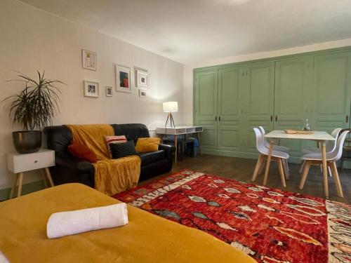 a living room with a couch and a table at Demeure d'autrefois in Passins