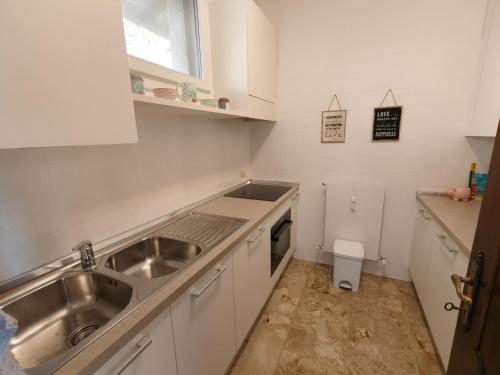 a small kitchen with a sink and a stove at Beautifull view at lake in Cima