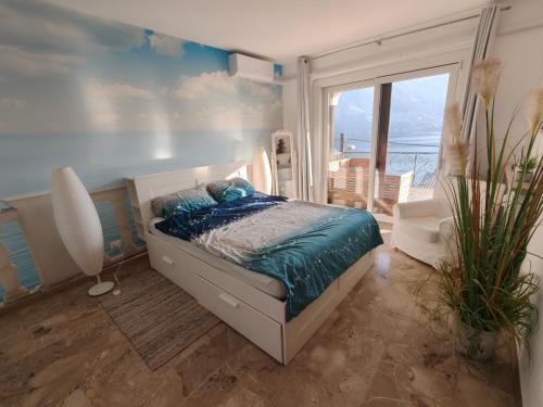 a bedroom with a bed with a view of the ocean at Beautifull view at lake in Cima
