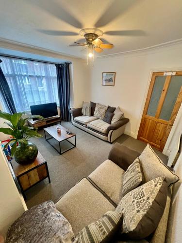 a living room with a couch and a table at Cosy & comfortable home in the heart of Loughborough in Loughborough