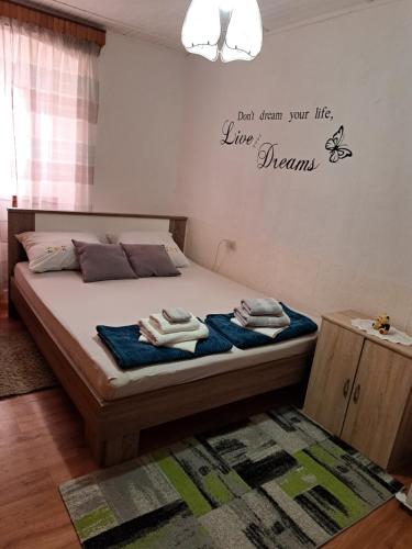 a bedroom with a bed with towels on it at Apartman Kadić Senj in Senj