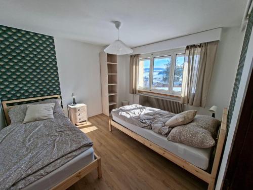 a bedroom with a bed and a window at Villa panorama 1000 in La Chaux-de-Fonds