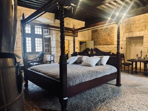 a bedroom with a canopy bed in a room at Château de Saint Maurice in La Peyrouse