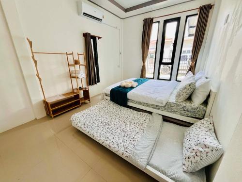 a bedroom with two beds and a window at Comfort Home stay Private Room A Shared House in Ban Tha Khun