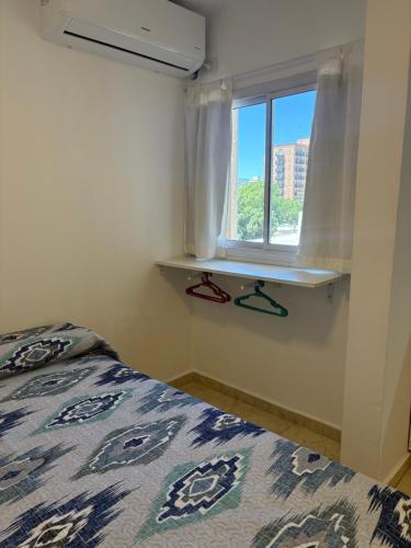 a bedroom with a bed and a window at Amelia 2-4 in Villa Carlos Paz
