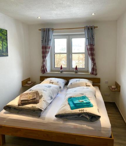a bed in a bedroom with two pillows on it at Allgäu-Chalet Kaufbeuren in Kaufbeuren