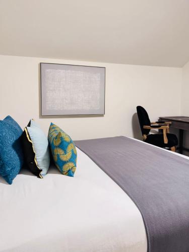 a bedroom with a bed with pillows on it at Modern Queen Room Ensuite Bathroom Vancouver West in Vancouver